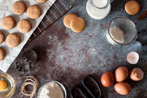 Free photo top view cookies with eggs and flour