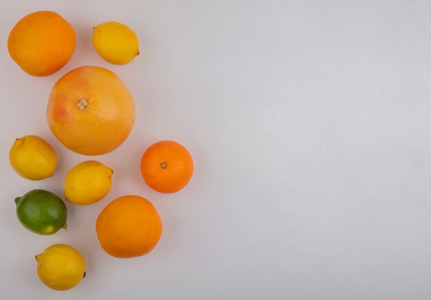 Top view  copy space grapefruits with oranges and lemons on white background