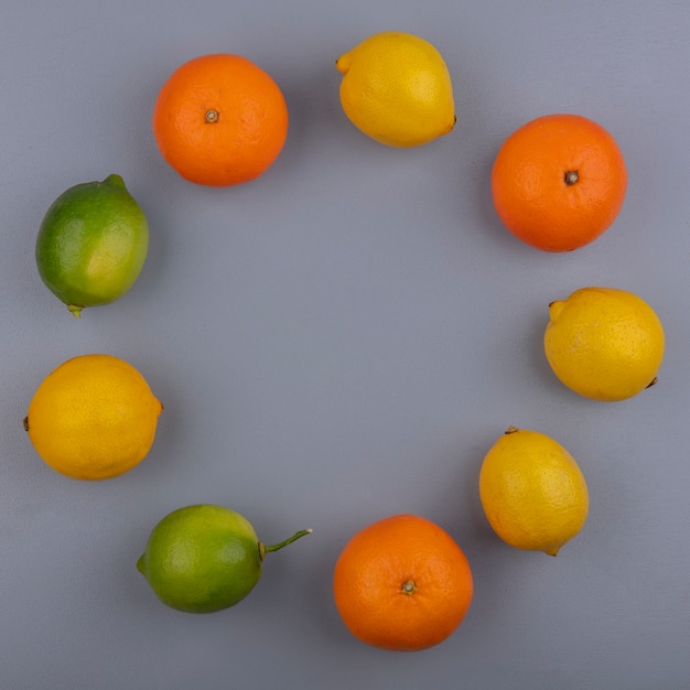 Free Photo top view  copy space oranges with lemons and limes on gray background