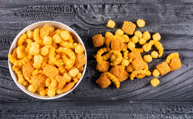 Top view of corn balls in bowl on dark  horizontal