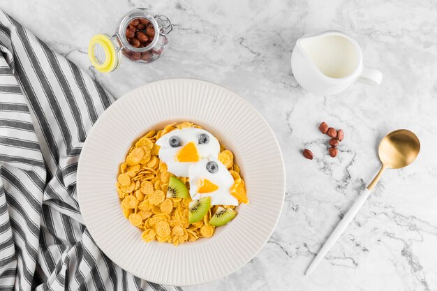 Top view cornflakes with fruits and yougurt