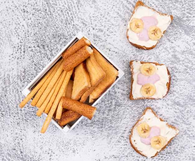 Free photo top view of crackers and toasts on white surface horizontal