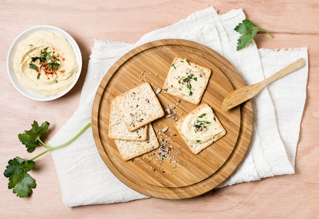 Free Photo top view of crackers with bowl of hummus