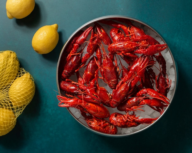 Free Photo top view crawfish and lemons still life