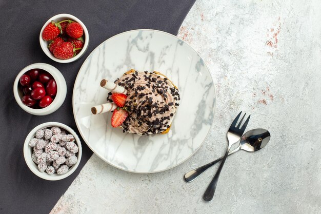 Top view creamy delicious cake with fresh fruits on the white surface birthday tea biscuit sweet cream cake