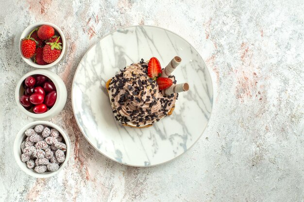 Top view creamy delicious cake with fresh fruits on the white surface birthday tea cake biscuit sweet cream