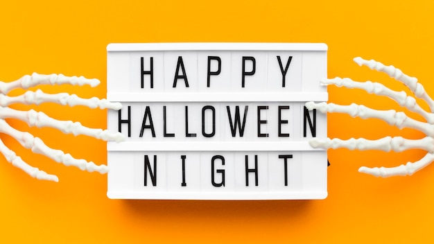 Free photo top view creepy halloween concept with greeting