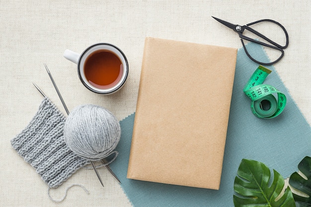 Free photo top view of crochet set with tea and yarn