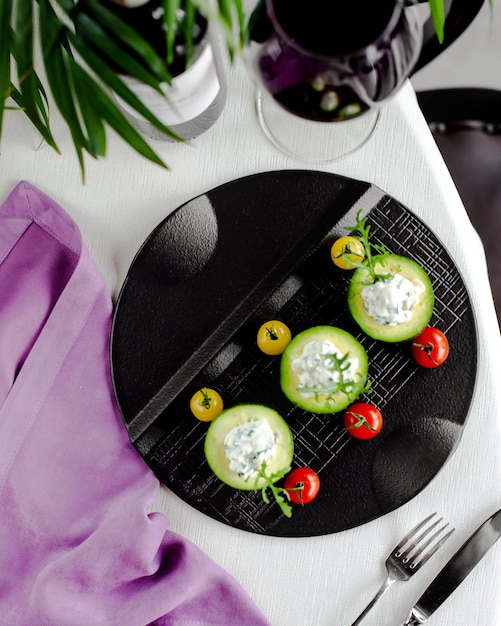 Free Photo top view of cucumber slices topped with creamy side dish