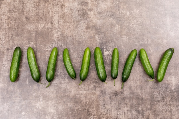 Free photo top view cucumber with copy space on gray stone  horizontal