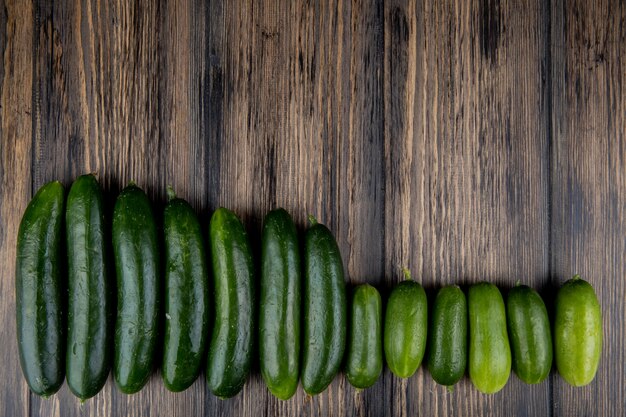 Top view of cucumbers on wooden surface with copy space