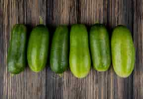 Free photo top view of cucumbers on wooden surface