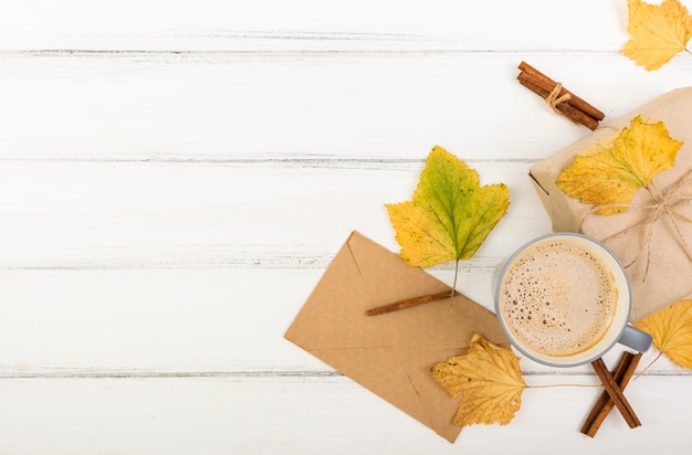 Top view cup of coffee next to envelope with copy space