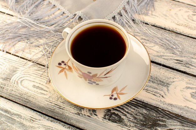 Top view of cup of coffee hot and strong on the grey wooden desk