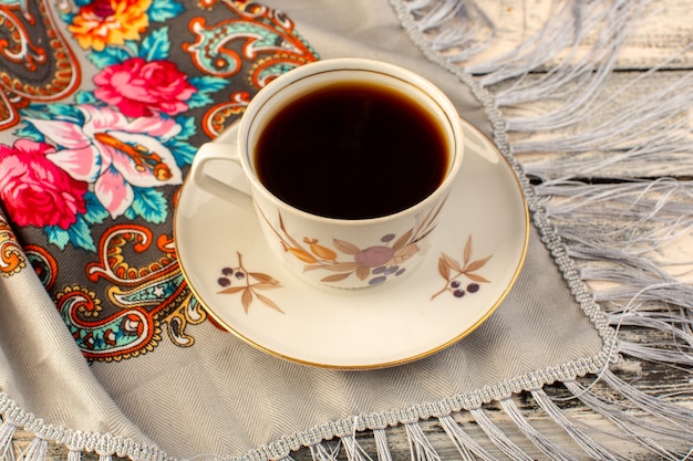 Top view of cup of coffee hot and strong on the grey wooden desk