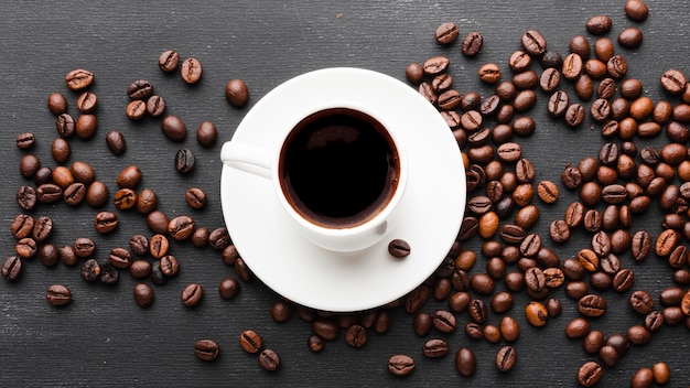 Top view cup of coffee with beans