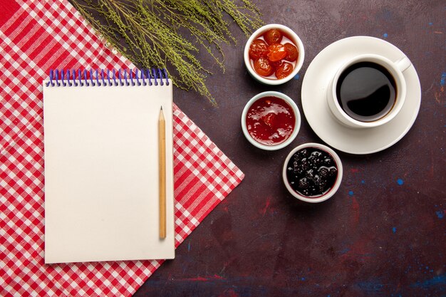 Top view cup of coffee with fruit jams on dark background fruit jam coffee sweet