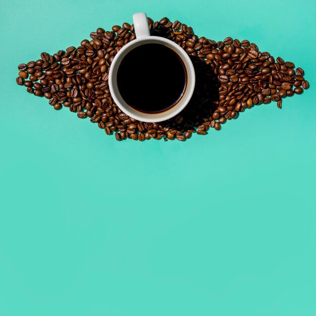 Top view cup of coffee with grains