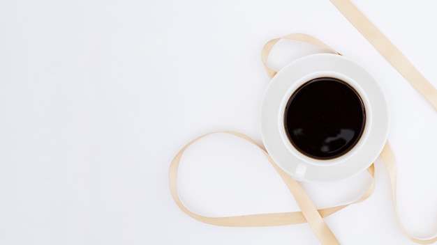 Top view cup of coffee with ribbon