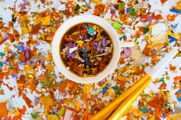 Free photo top view cup full of colorful confetti