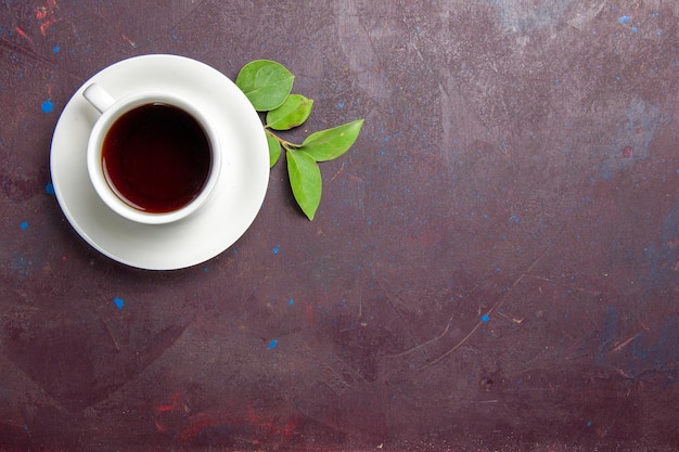 Top view cup of tea on a dark space