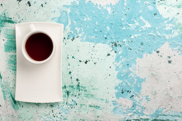 Free Photo top view cup of tea inside cup and plate on light-blue surface