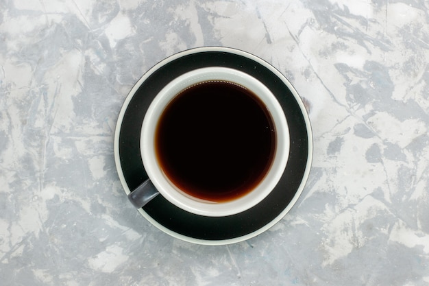 Top view cup of tea inside cup and plate on light-white surface