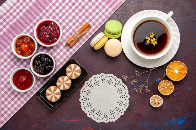 Top view cup of tea inside plate and cup on dark surface tea drink color photo sweet