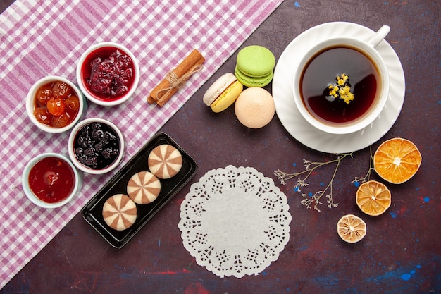 Top view cup of tea inside plate and cup on dark surface tea drink color photo sweet