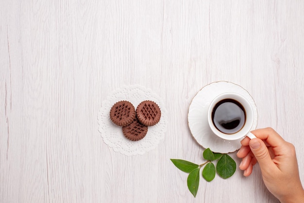 Top view cup of tea with chocolate cookies on the white desk sugar tea cookies sweet biscuit