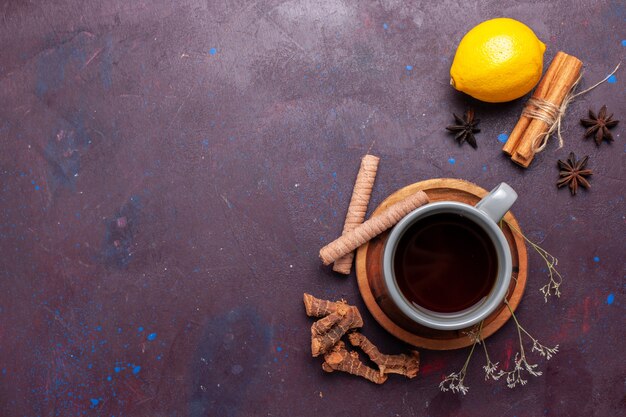 Top view cup of tea with cinnamon and lemon on dark desk tea sweet color photo