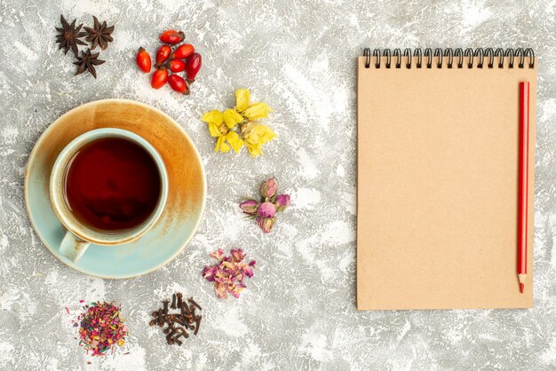 Top view cup of tea with dry flowers on a white background tea drink flower flavor