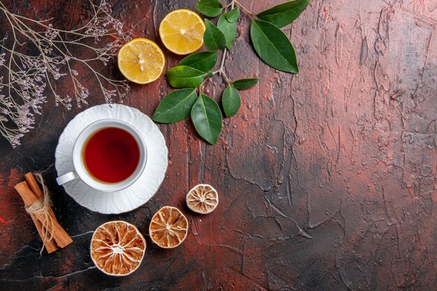 Top view cup of tea with lemon on dark table sugar tea photo biscuit sweet