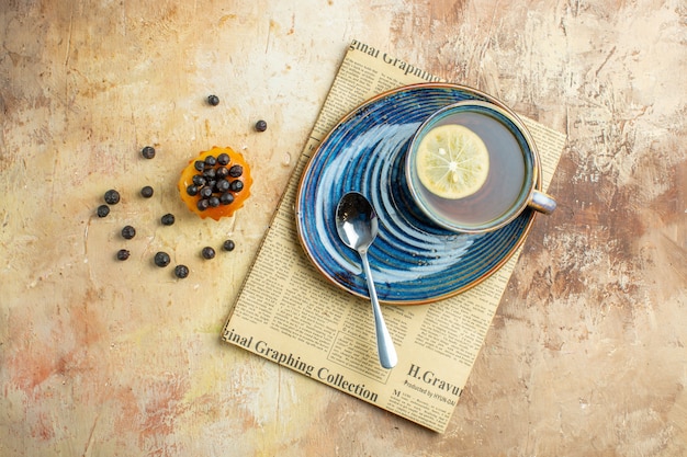 Top view cup of tea with lemon slice on a light background