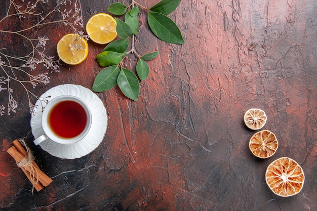 Top view cup of tea with lemon slices on dark table sugar tea photo biscuit sweet