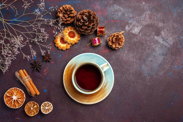 Top view cup of tea with little cookies on dark background sugar biscuit cookie sweet