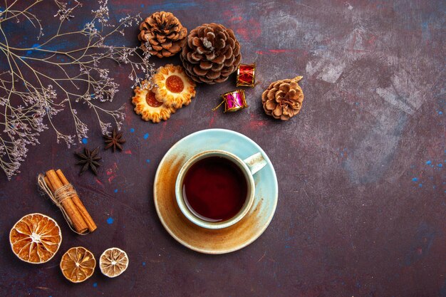 Top view cup of tea with little cookies on dark background sugar biscuit cookie sweet