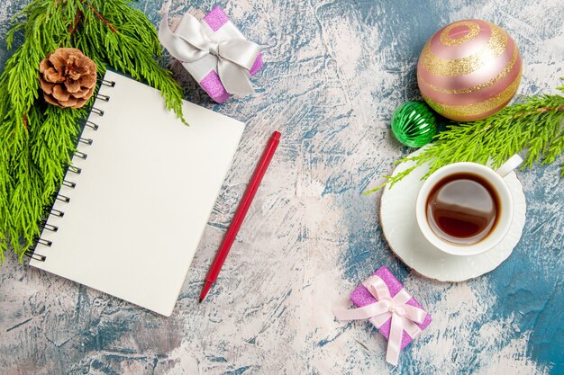 Top view cup of tea with notepad and green branch