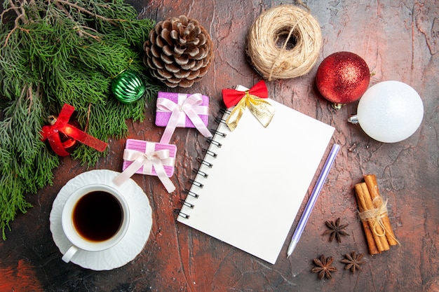 Top view cup of tea with notepad and toys