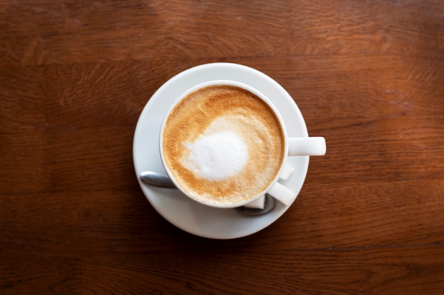 Top view cup with delicious coffee on table