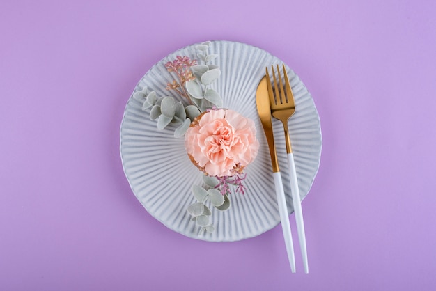 Top view cupcake with flower on plate