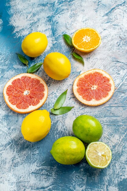 Top view cut grapefruits lemons on blue white surface