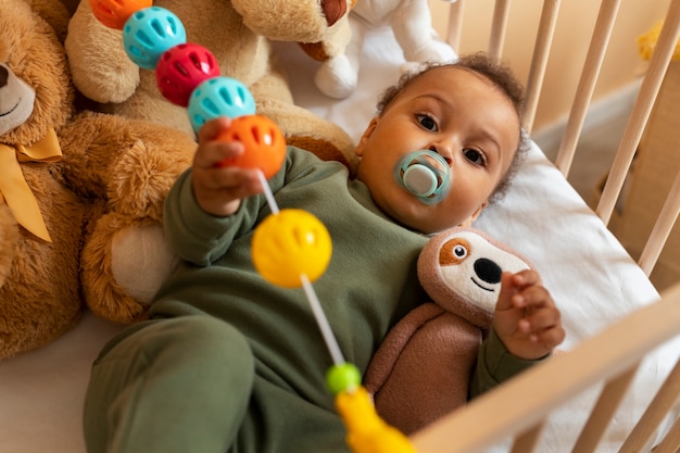 Free Photo top view cute baby with stuffed animal