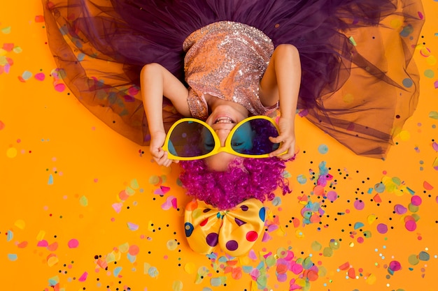 Top view of cute girl with clown wig and big sunglasses