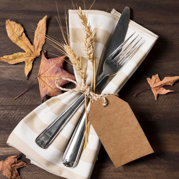 Top view cutlery with autumn leaves