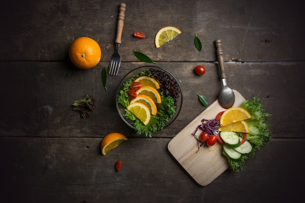 Free photo top view of cutting board with ingredients for salad