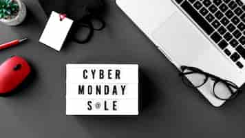 Free photo top view of cyber monday laptop with light box and glasses