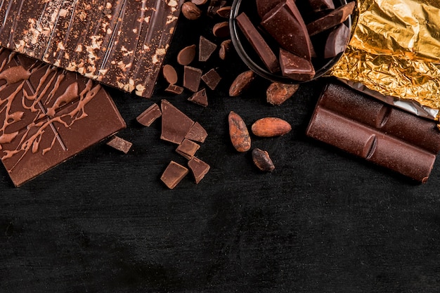 Free photo top view dark assortment with chocolate with copy space