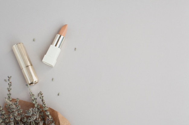 Top view decoration with brown lipstick and plant 