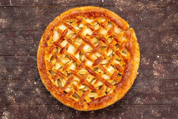 Free photo a top view delicious apple cake round shaped on the brown background cake biscuit sugar  fruit